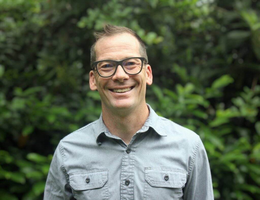 Nathan Hensley official headshot, leaves in background