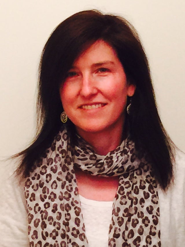 Headshot of Lisbeth Fuisz; a brunette woman wearing a patterned scarf.